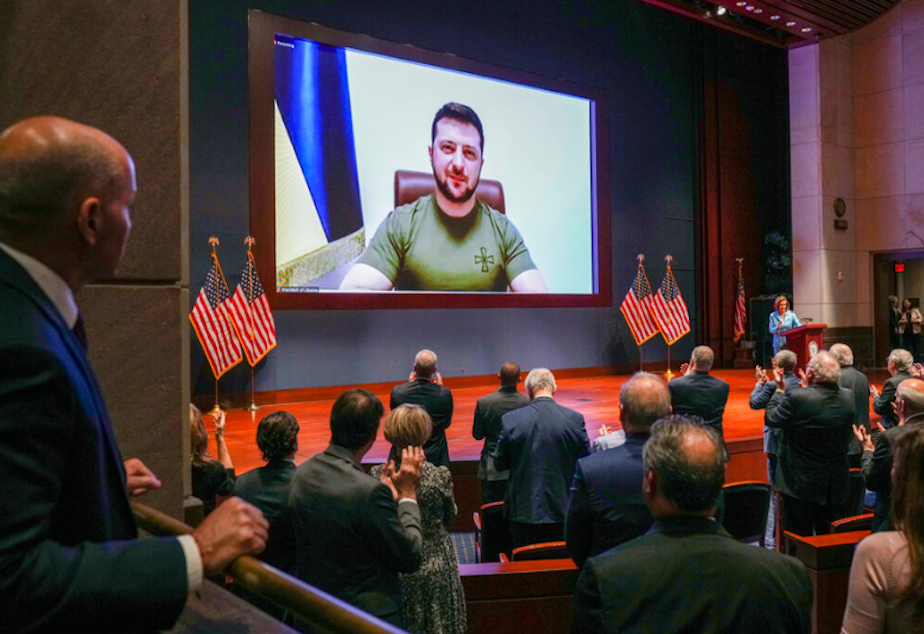 caption: Members of Congress give Ukraine President Volodymyr Zelensky a standing ovation before he speaks in a virtual address to Congress in the U.S. Capitol Visitors Center Congressional Auditorium in Washington, Wednesday, March 16, 2022. 