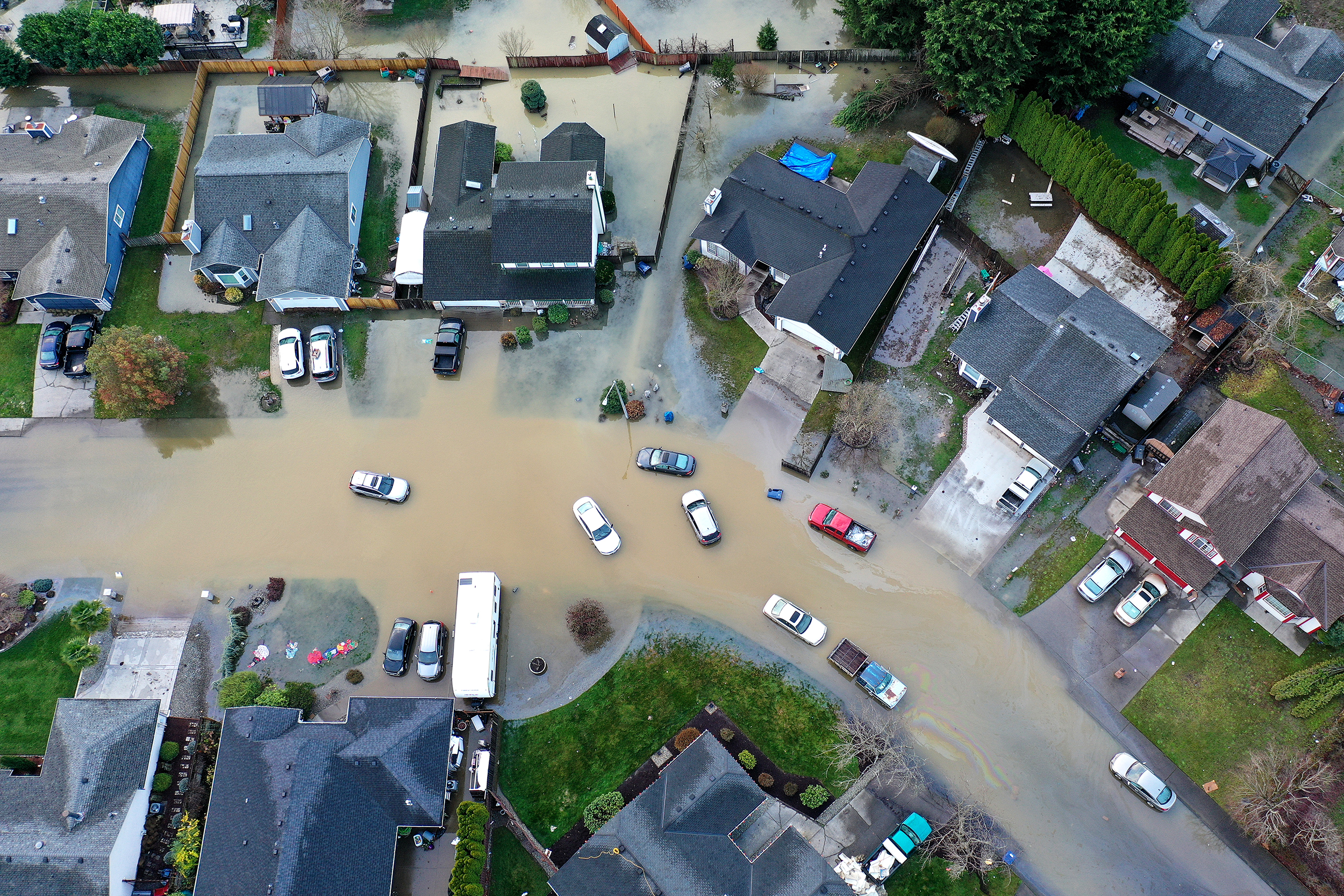 caption: Flooding from the White River is shown surrounding homes near Butte Avenue on Wednesday, December 17, 2025, in Pacific. 