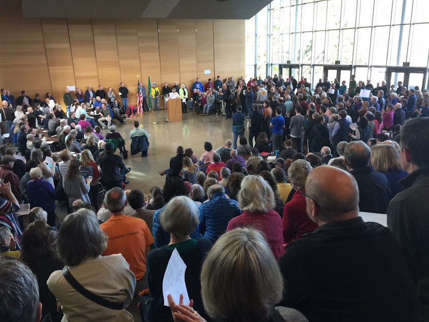 caption: A large crowd fills a hall on Bainbridge Island for the Democratic caucuses on Saturday, March 26.