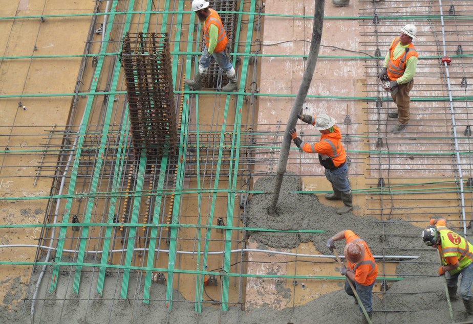 SLIDESHOW: Workers pour concrete for a floor of an office tower in Renton. Pouring concrete carries a lot of risk for workers.