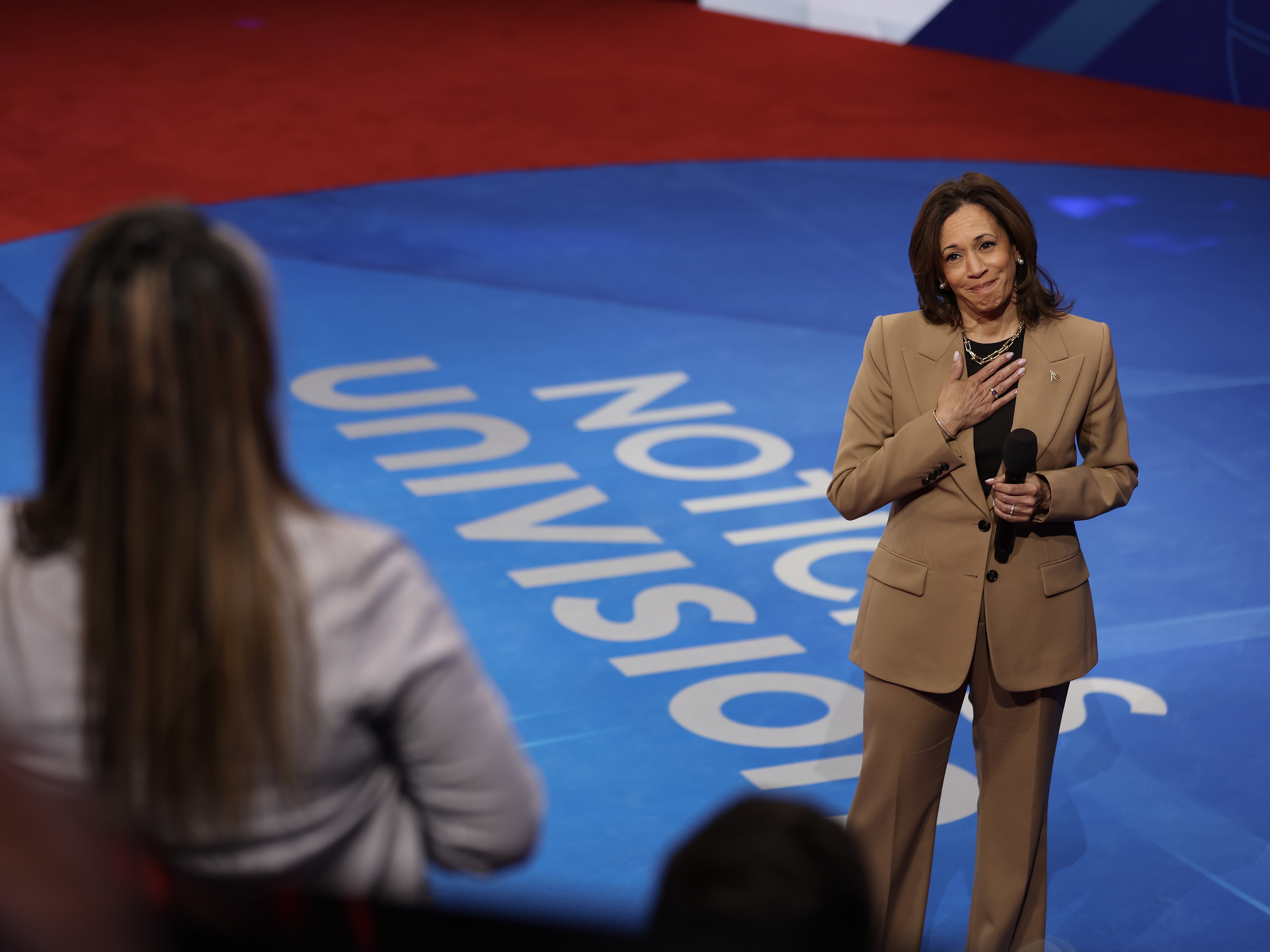 caption: Vice President Harris reacts as she takes a question from a member of the audience during a Univision town hall at Cox Pavilion at UNLV in Las Vegas on Thursday.