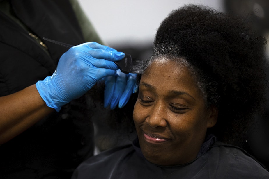 caption: DaVonna Johnson has her hair colored by Nina Trapp during an appointment at Mati’s Salon and Barbershop on Friday, May 24, 2024, along Rainier Avenue South in Seattle. 