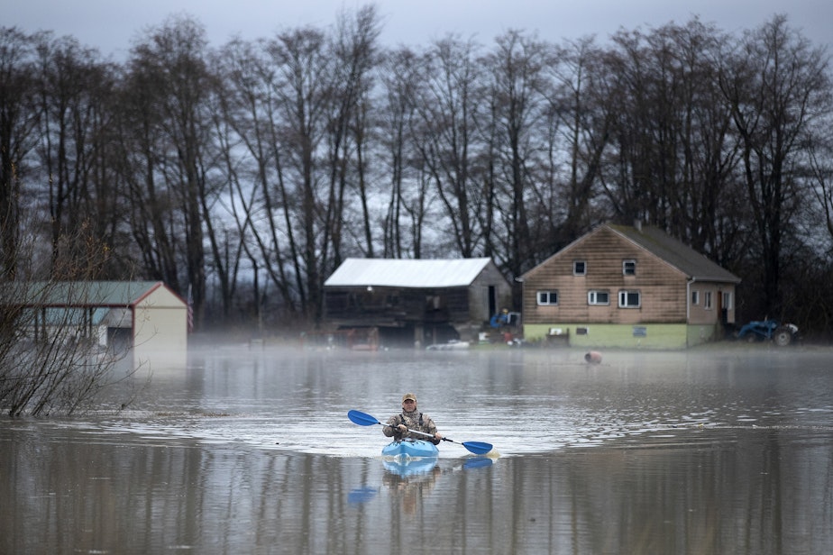 caption: Todd Torgeson kayaks from his home to where his truck is parked along on Francis Road, after flooding the previous day, on Wednesday, Dec. 6, 2023, in Clear Lake.