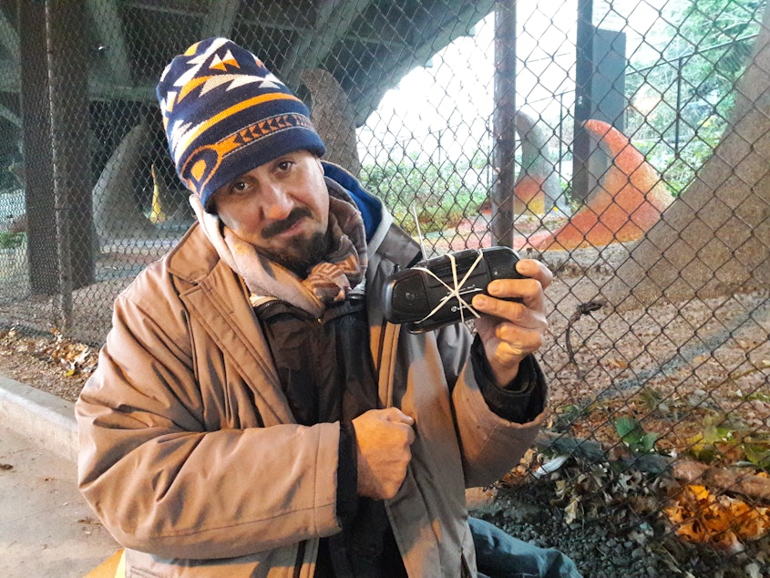 caption: Gabrielitto Rodriguez Barcelotta, at his camping spot in Belltown, does not mind the bike racks that now discourage camping here and separate him from traffic. But bike advocates do mind the city's use of bike racks for this purpose.