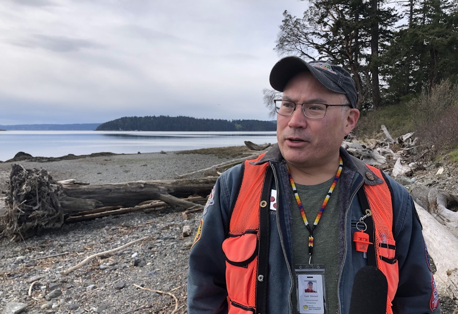 caption: Todd Mitchell is the environmental director for the Swinomish Tribe. Behind him is the south beach of the Kukutali Preserve. 