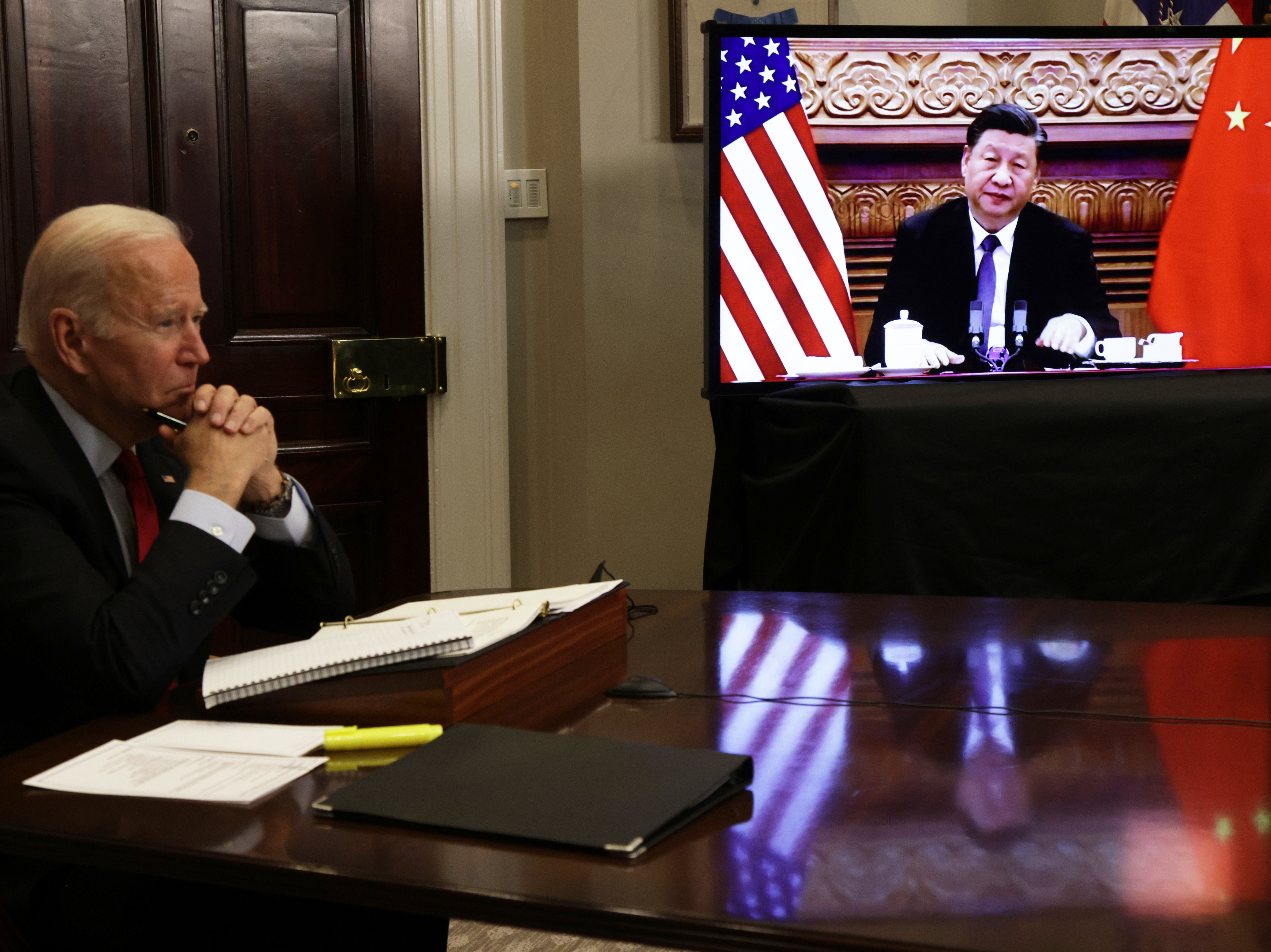caption: President Biden participates in a virtual meeting with Chinese President Xi Jinping at the Roosevelt Room of the White House Monday.