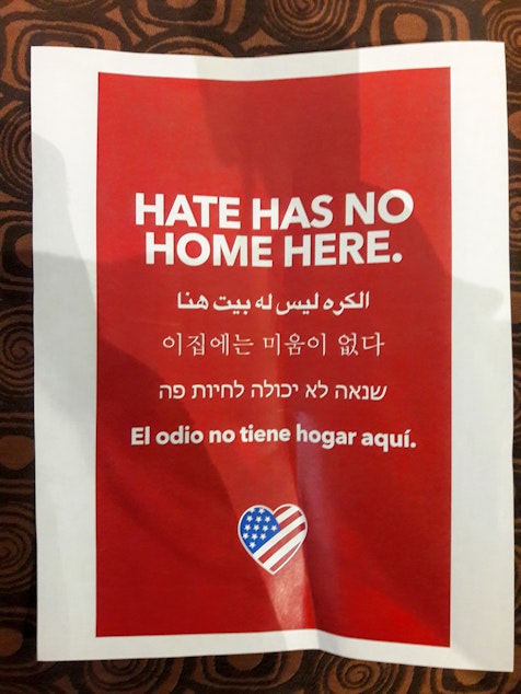 caption: This sign was posted to the front door of Skyline High School on Monday. The school is just a few minutes away from where the racist vandalism occurred.