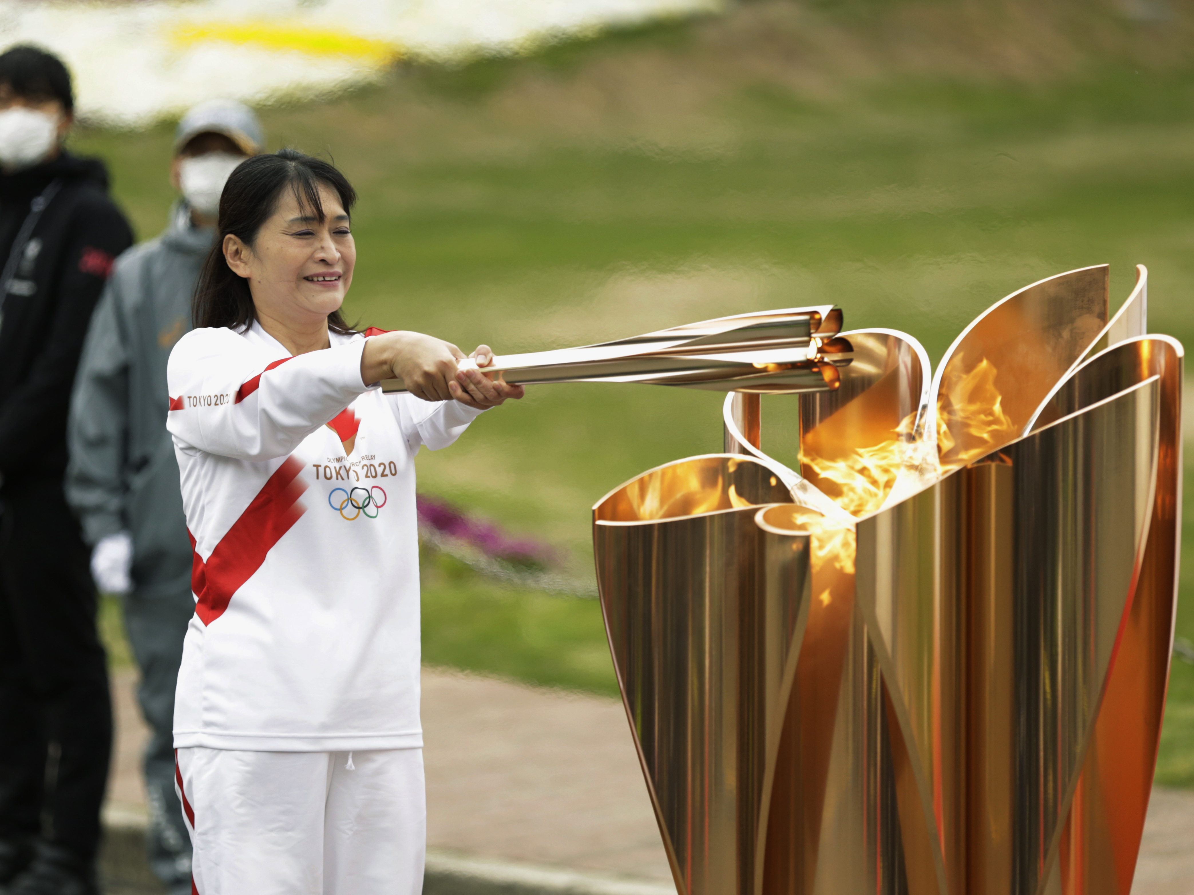 caption: The last Olympic torch relay runner for the Osaka leg concludes the event in Suita, north of Osaka, western Japan, last month.