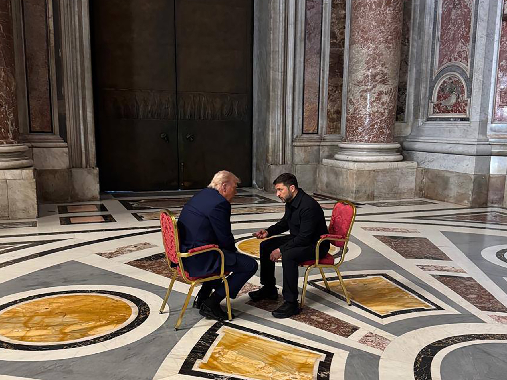 caption: A photo provided by the Ukrainian Presidential Press Office shows Ukrainian President Volodymyr Zelenskyy (right) and President Trump, talking as they attend the funeral of Pope Francis in the Vatican, April 26.
