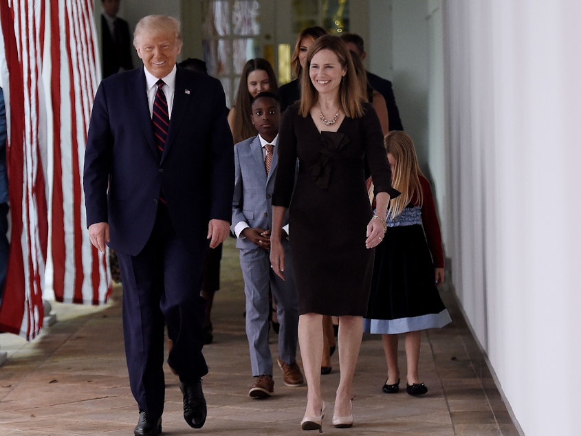 caption: President Trump and Judge Amy Coney Barrett walk to the Rose Garden of the White House in Washington, DC., on Sept. 26.