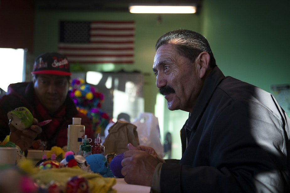 caption: Adolfo Garcia paints a calavera in preparation for the Day of the Dead altar on Tuesday, October 29, 2019, at Casa Latina in Seattle.