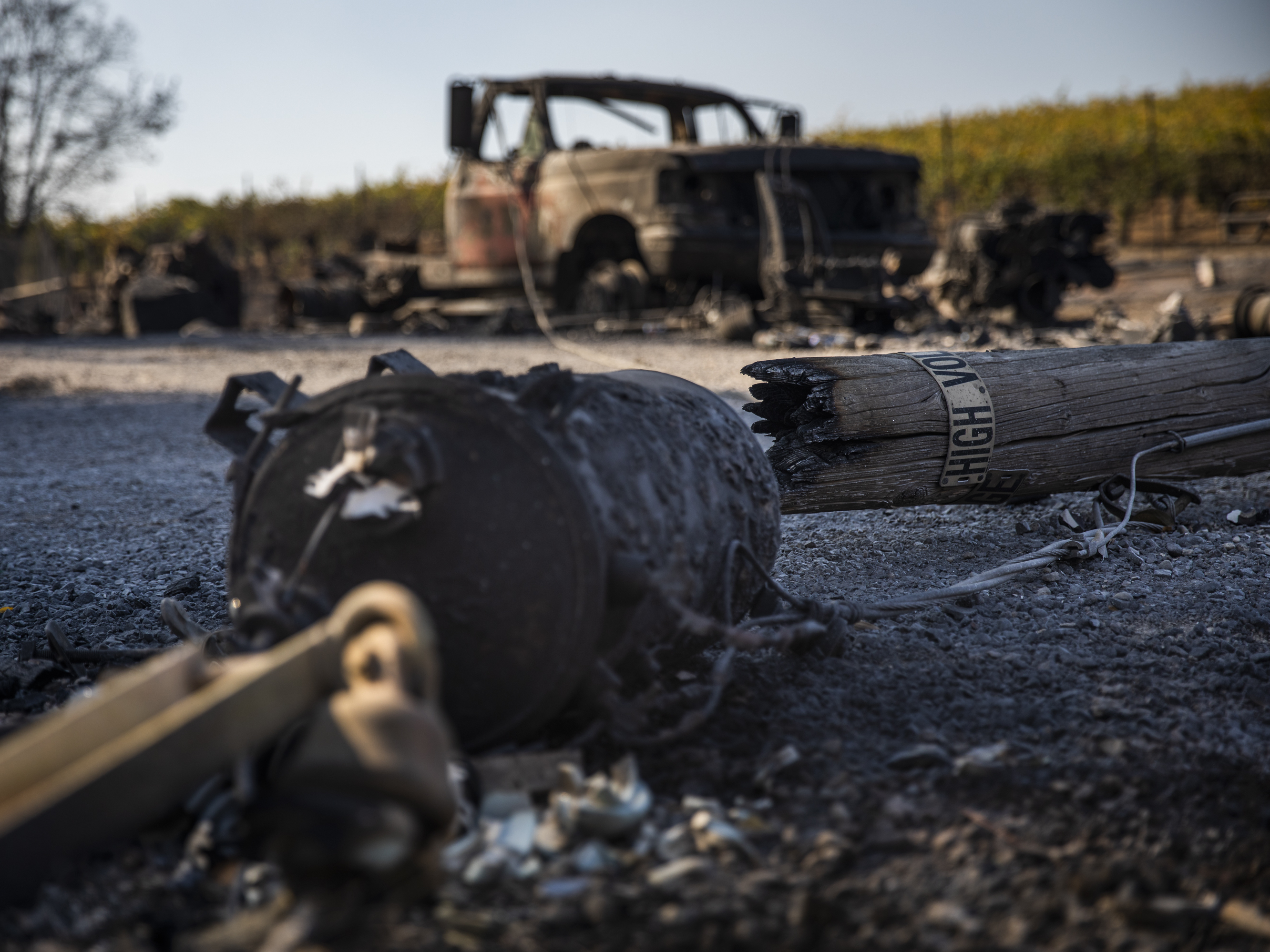 caption: A PG&E utility pole rests on a burned-out property in Healdsburg, Calif., on Monday. The community was just one of many in Sonoma County affected by the Kincade Fire, which has swelled to a size much larger than San Francisco.
