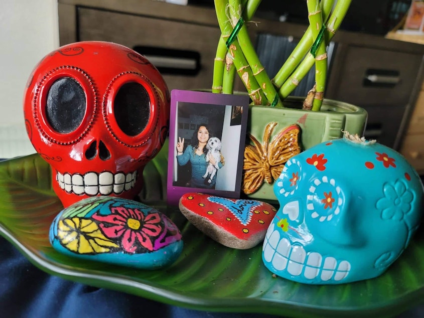 caption: RadioActive youth producer Antonio Nevarez lost his sister in 2019. He shares, "This is a photo of my sister that I keep in my wallet. She used to collect these colorful skulls, and the rocks that surround her are the ones she painted."