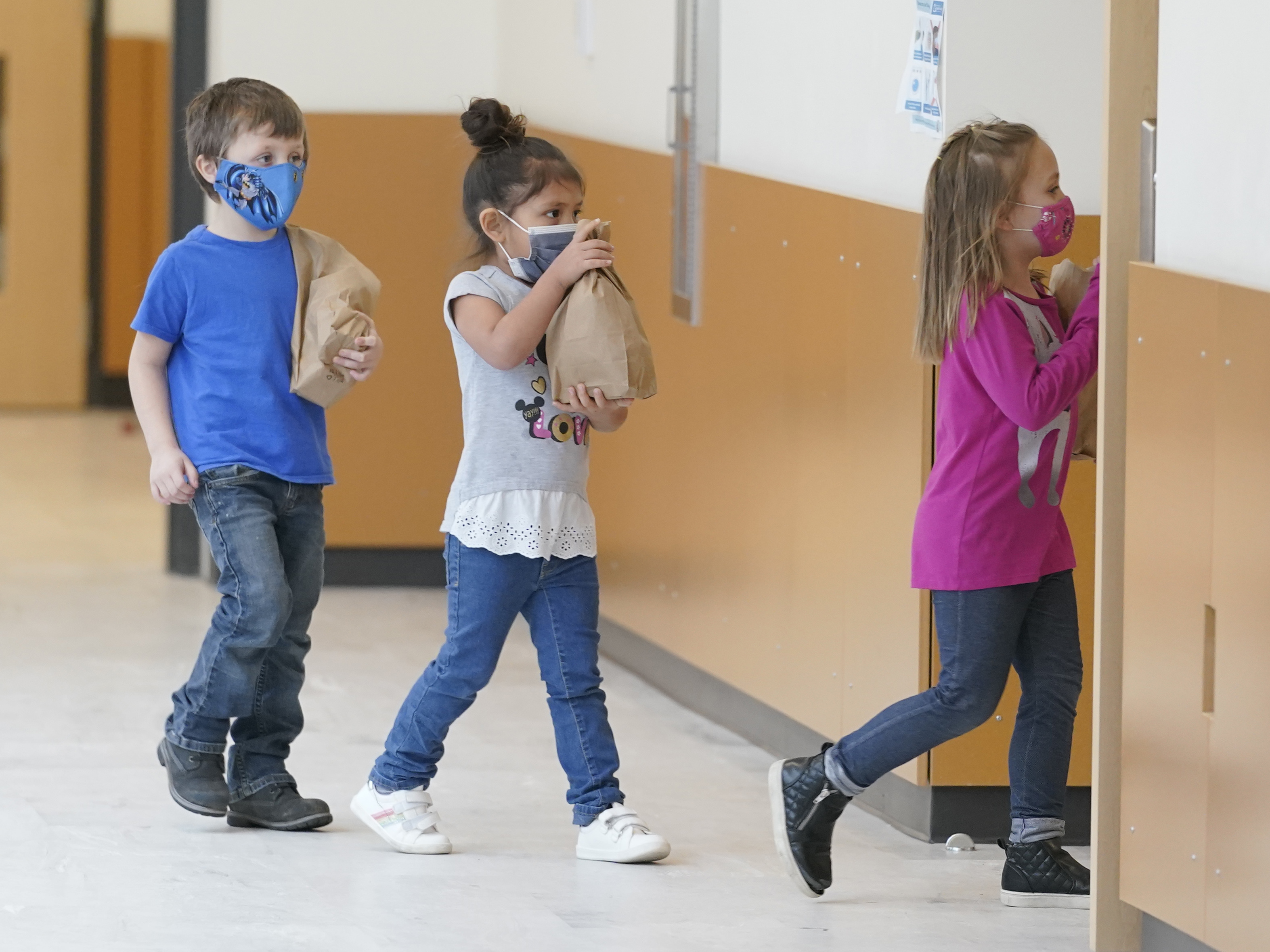 caption: Students carry sack lunches at Elk Ridge Elementary School in Buckley, Wash. On Monday, USDA unveiled a new program that would feed millions of children over the summer, when many schools are closed.