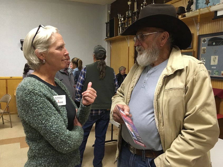 caption: Ann Diamond (an Independent from Mazama) talks with Ron Morris, an independent voter, at a recent candidates' forum in Brewster. 