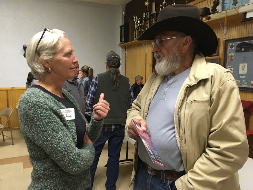 caption: Ann Diamond (an Independent from Mazama) talks with Ron Morris, an independent voter, at a recent candidates' forum in Brewster.