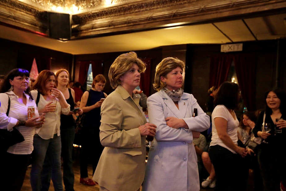 caption: Beth Harrott, left, and Annabelle Richardson, watch the election results come in at The Century Ballroom. And yes, those are wigs (not their real hair) and pant suits for Hillary, just to be clear.