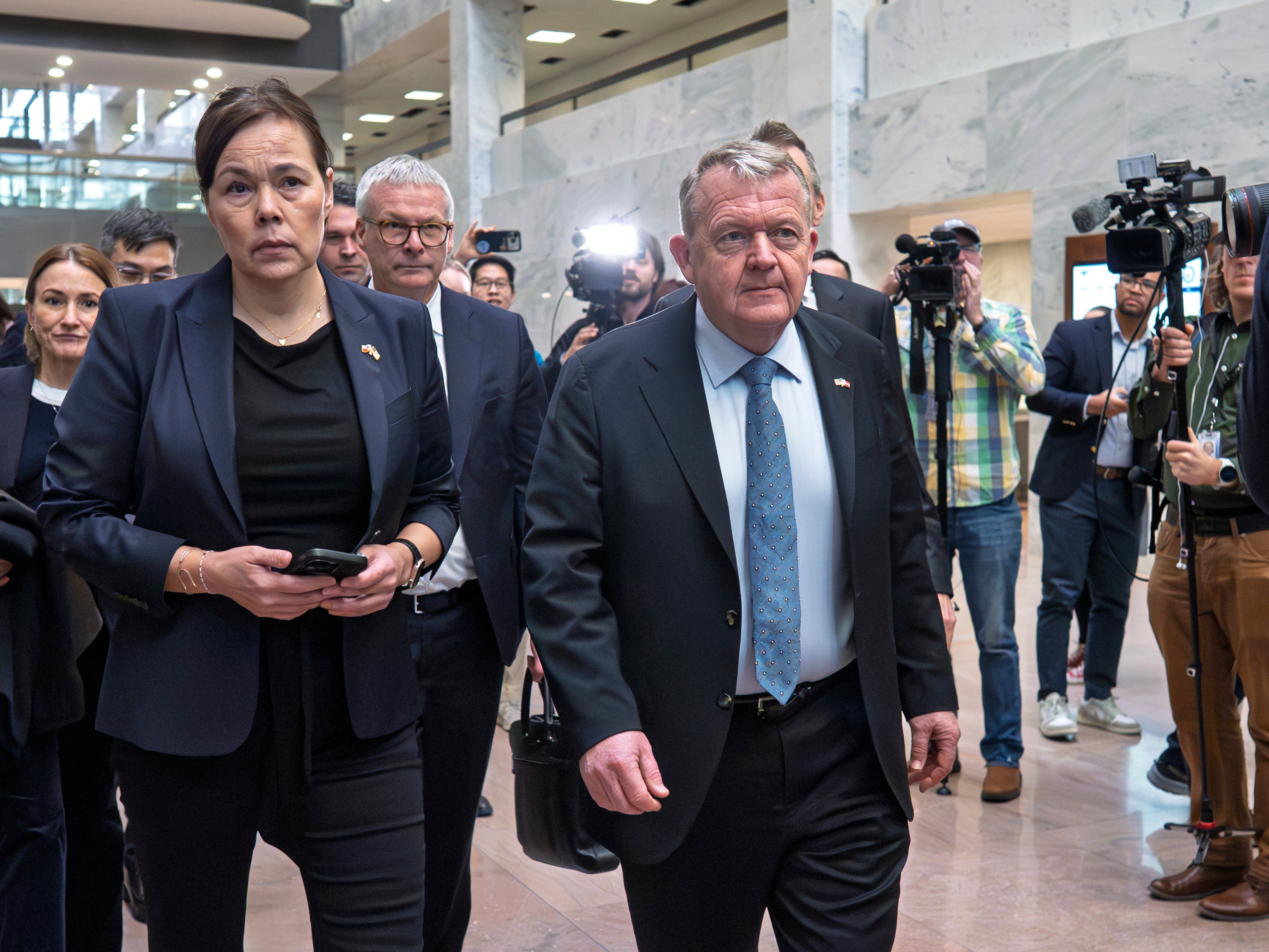 caption: Greenland Foreign Minister Vivian Motzfeldt, left, and Danish Foreign Minister Lars Løkke Rasmussen, arrive on Capitol Hill to meet with members of the Senate Arctic Caucus, in Washington, Wednesday, Jan. 14, 2026.