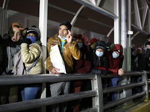 caption: Cuban migrants block the Paso del Norte-Santa Fe international bridge between Mexico and the United States, to demand that the Trump administration allow them to wait for their asylum process on U.S. soil, in Ciudad Juarez, Mexico, on Dec. 29, 2020.