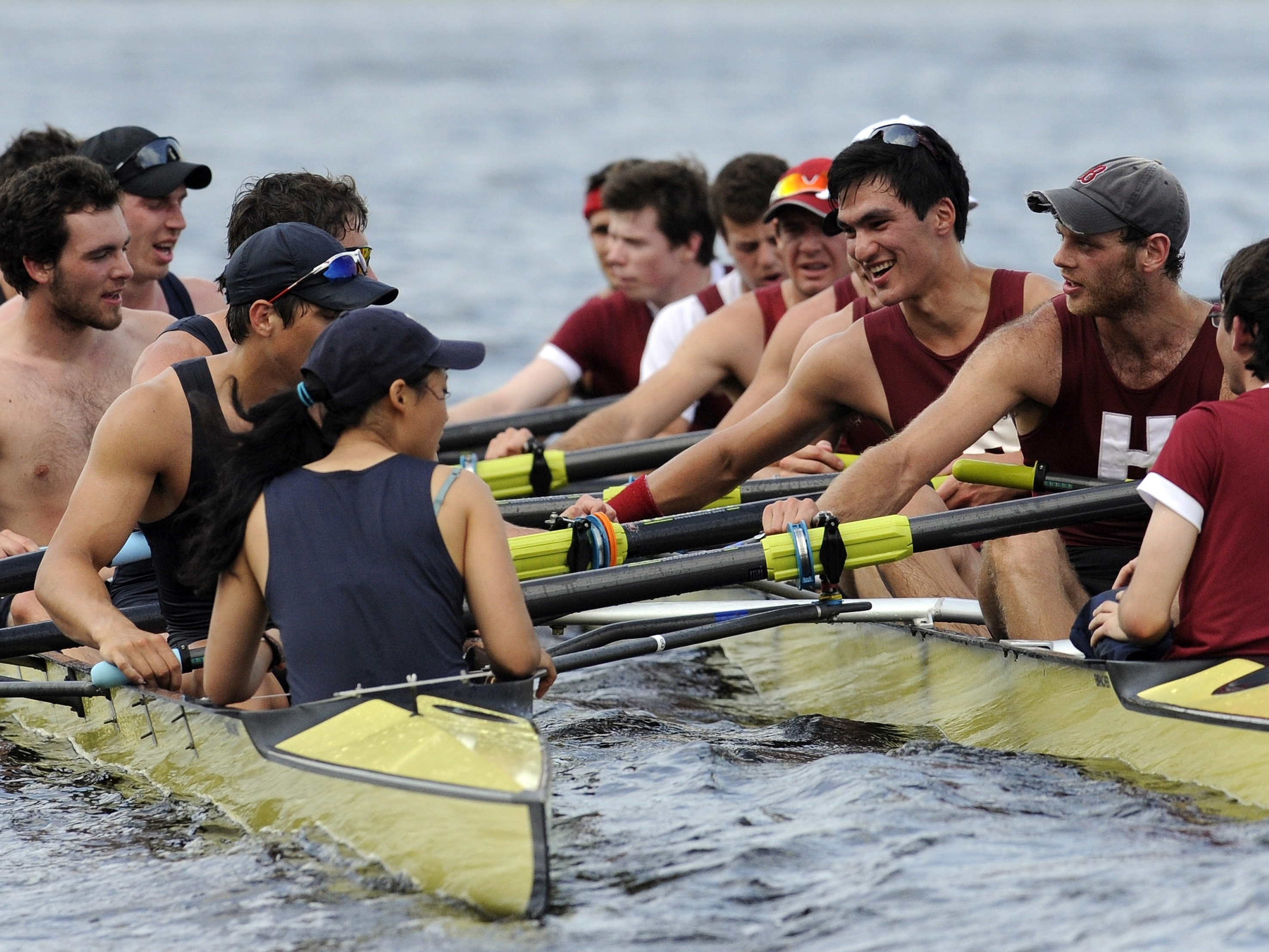 caption: Members of Yale crew, left, and Harvard crew, right, greet one another after the 4-mile course along the Thames River for the 146th Harvard-Yale Regatta, in New London, Conn., on May 28, 2011.