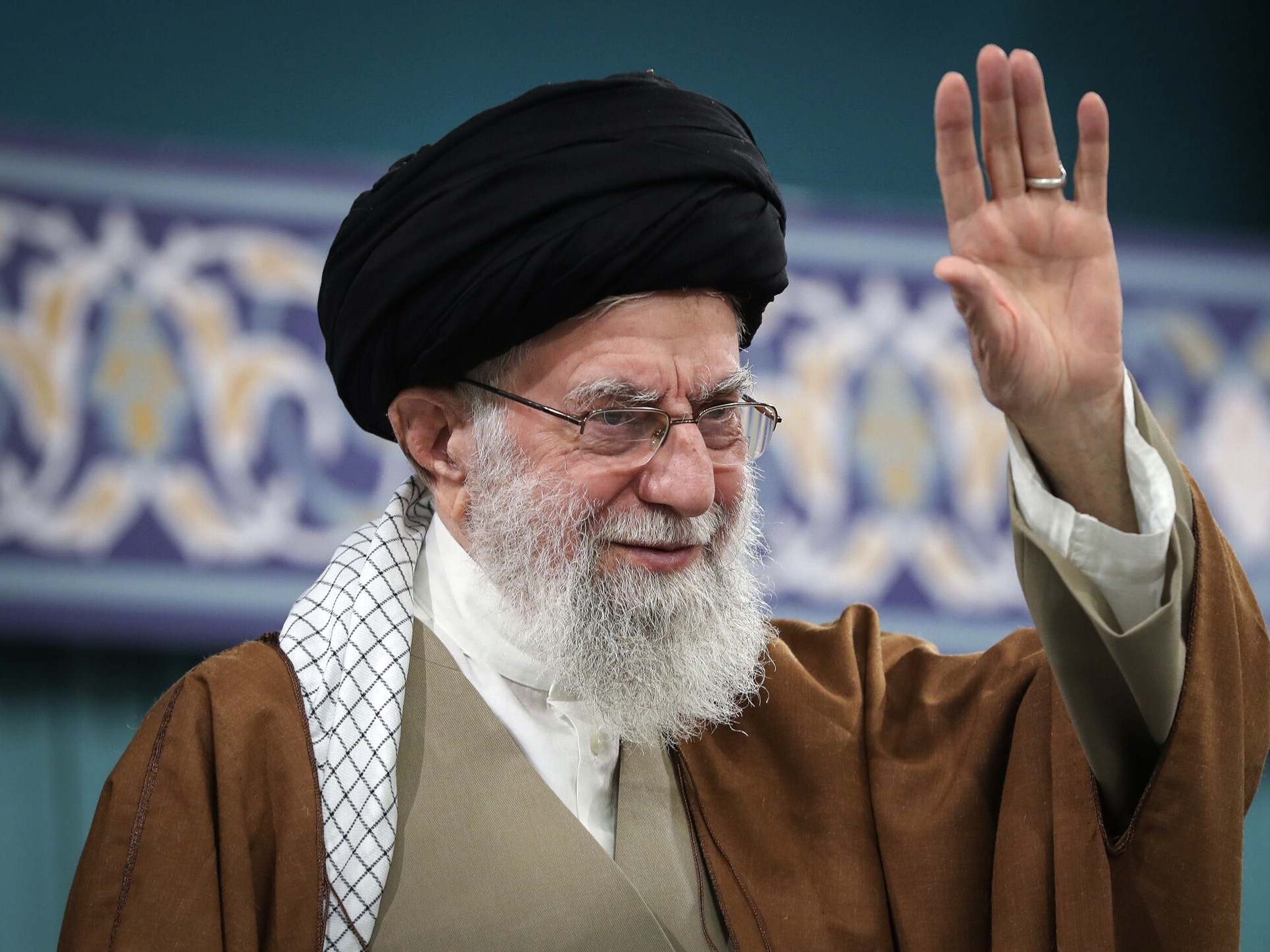 caption: Iranian Supreme Leader Ayatollah Ali Khamenei waves to the crowd in Tehran, Iran, March 31.