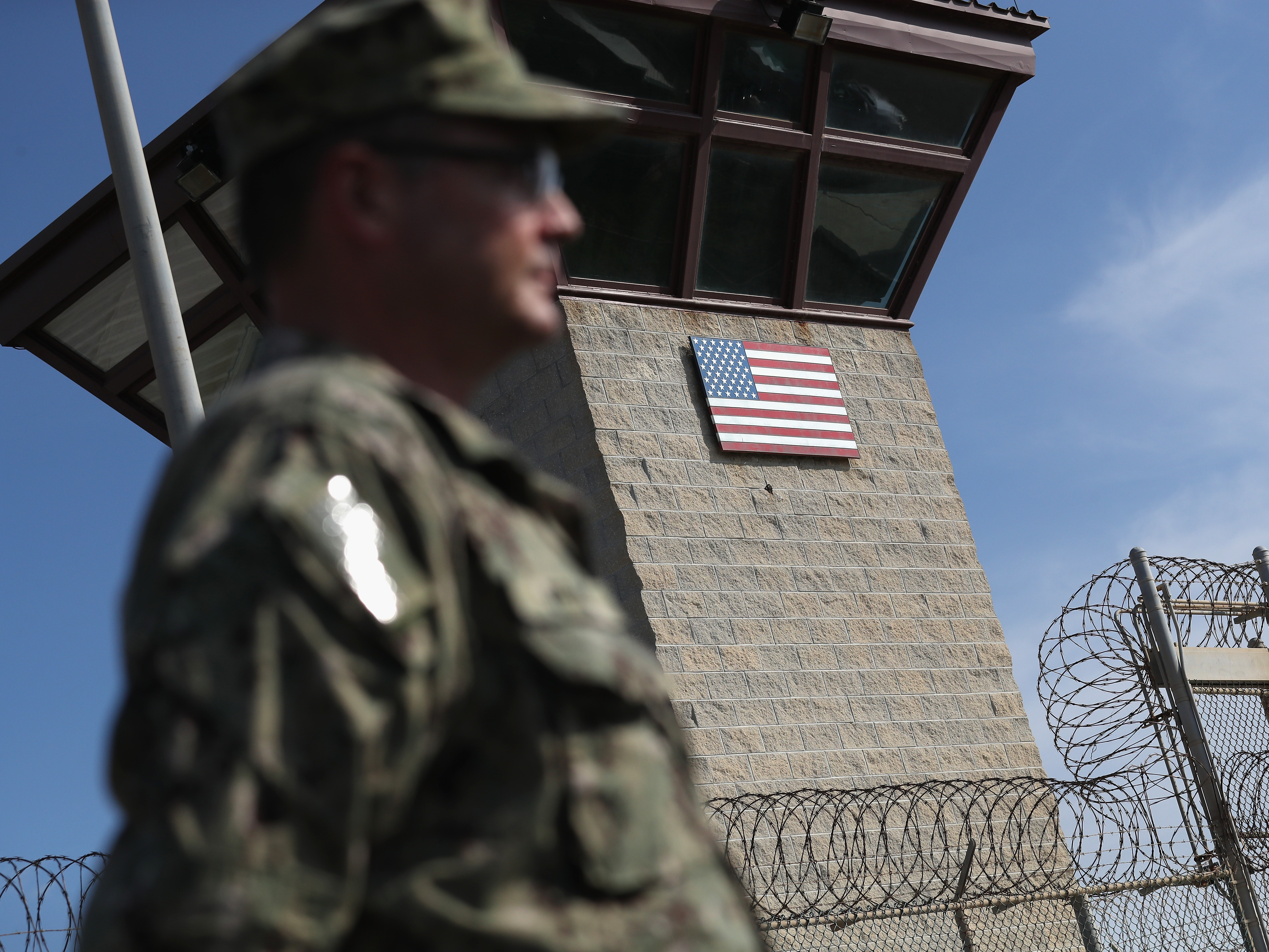 caption: A U.S. Naval officer stands at the entrance of the U.S. prison at the U.S. Naval Station at Guantánamo Bay, Cuba, on Oct. 22, 2016.