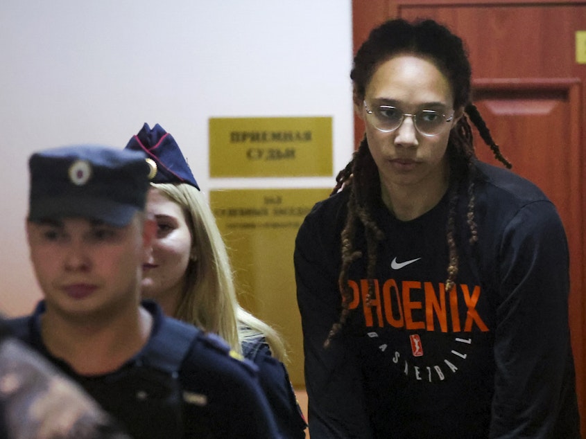 caption: WNBA star and two-time Olympic gold medalist Brittney Griner is escorted to a courtroom for a hearing, in Khimki just outside Moscow, on Wednesday.