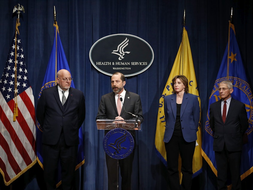 caption: Dr. Nancy Messonnier stands with other Trump administration officials during an early briefing about the coronavirus in January 2020. From left: Dr. Robert Redfield, former CDC director; Alex Azar, former HHS secretary; Messonnier; Dr. Anthony Fauci, NIAID director.