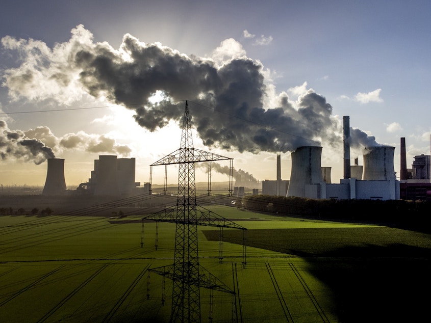 caption: Steam rises from the coal-fired power plant Neurath in November 2022 near Grevenbroich, Germany.