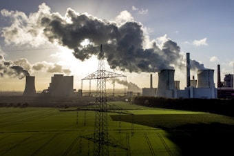 caption: Steam rises from the coal-fired power plant Neurath in November 2022 near Grevenbroich, Germany.