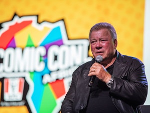 caption: Canadian actor William Shatner, who became a cultural icon for his portrayal of Captain James T. Kirk in the Star Trek franchise, speaks from the stage at the second edition of the multi-genre entertainment comic and fan convention 'Comic Con Africa' in Johannesburg on September 21, 2019.