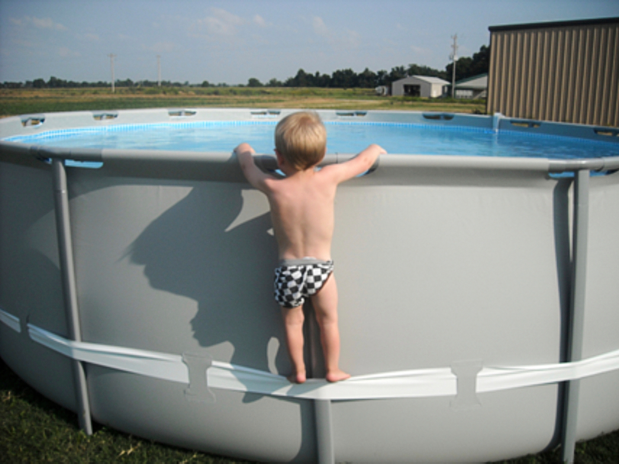 caption: In this undated image provided by the CPSC, a child uses the compression strap to stand on above-ground pool. (CPSC via AP)