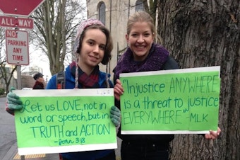 caption: Holy Names students Audrey Long and Theresa Edwards at a December rally outside the Archdiocese of Seattle in support of former Eastside Catholic Vice Principal Mark Zmuda.