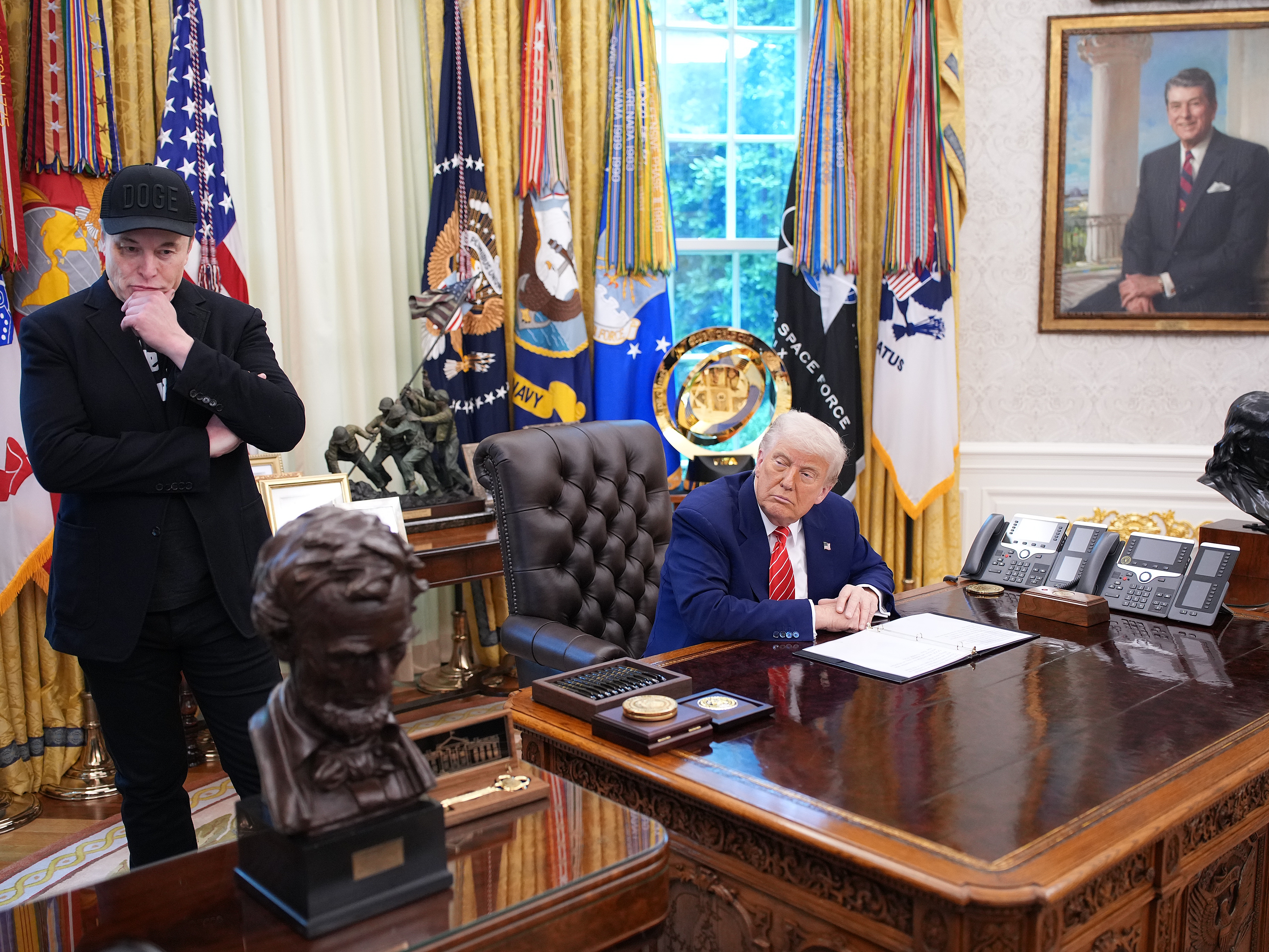 caption: Elon Musk and President Trump speak with reporters in the Oval Office of the White House on May 30.