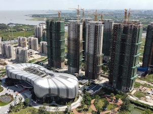 caption: This aerial photo taken on September 17, 2021 shows the halted under-construction Evergrande Cultural Tourism City, a mixed-used residential-retail-entertainment development, in Taicang, Suzhou city, in China's eastern Jiangsu province. (Photo by Vivian LIN / AFP) (Photo by VIVIAN LIN/AFP via Getty Images)