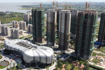 caption: This aerial photo taken on September 17, 2021 shows the halted under-construction Evergrande Cultural Tourism City, a mixed-used residential-retail-entertainment development, in Taicang, Suzhou city, in China's eastern Jiangsu province. (Photo by Vivian LIN / AFP) (Photo by VIVIAN LIN/AFP via Getty Images)