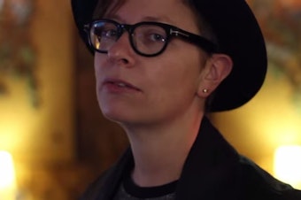 caption: Local musician Jamie Aaron, in a screenshot from one of her music videos. 