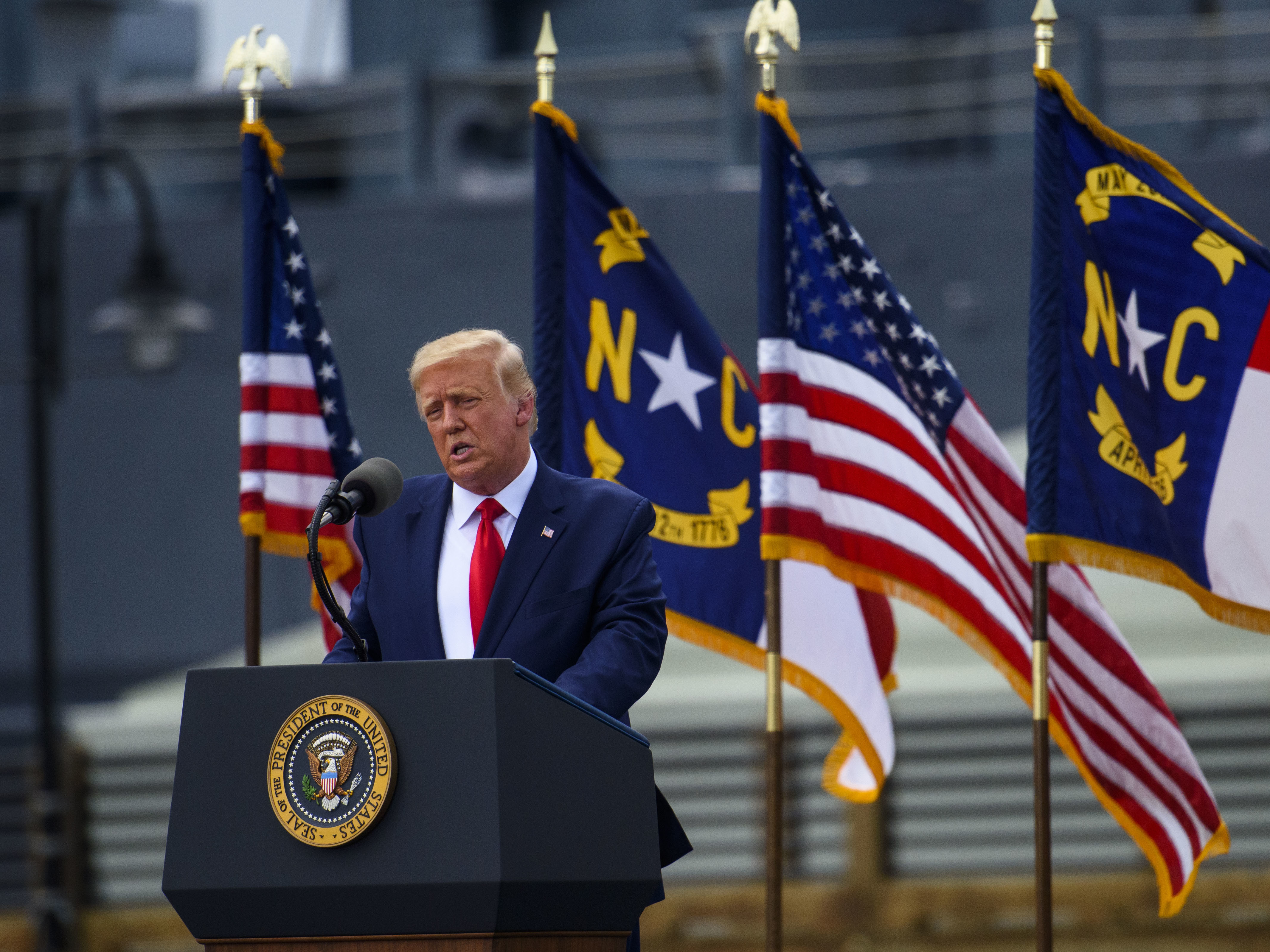 caption: President Trump visited Wilmington, N.C., on Wednesday and urged supporters to try to vote in person after sending in a mail-in ballot — actions that would be both illegal and disruptive.