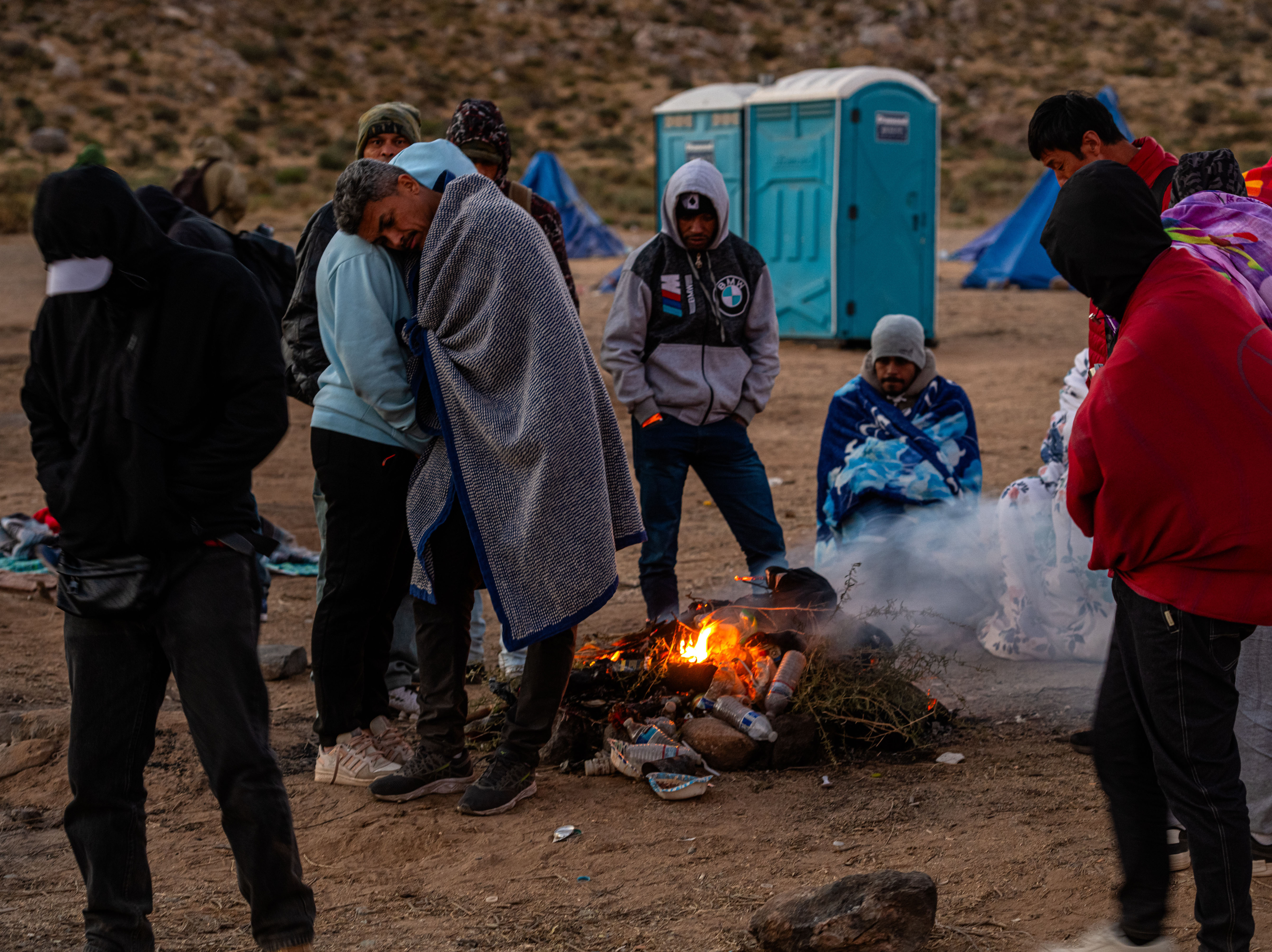 caption: Locals say U.S. Border Patrol is delivering hundreds of migrants into a series of camps, one of which is on private property, in the border community of Jacumba in the Southern California desert. Overnight temperatures in the desert have begun to drop below freezing.