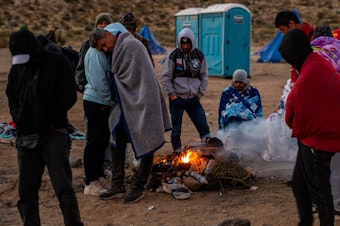 caption: Locals say U.S. Border Patrol is delivering hundreds of migrants into a series of camps, one of which is on private property, in the border community of Jacumba in the Southern California desert. Overnight temperatures in the desert have begun to drop below freezing.