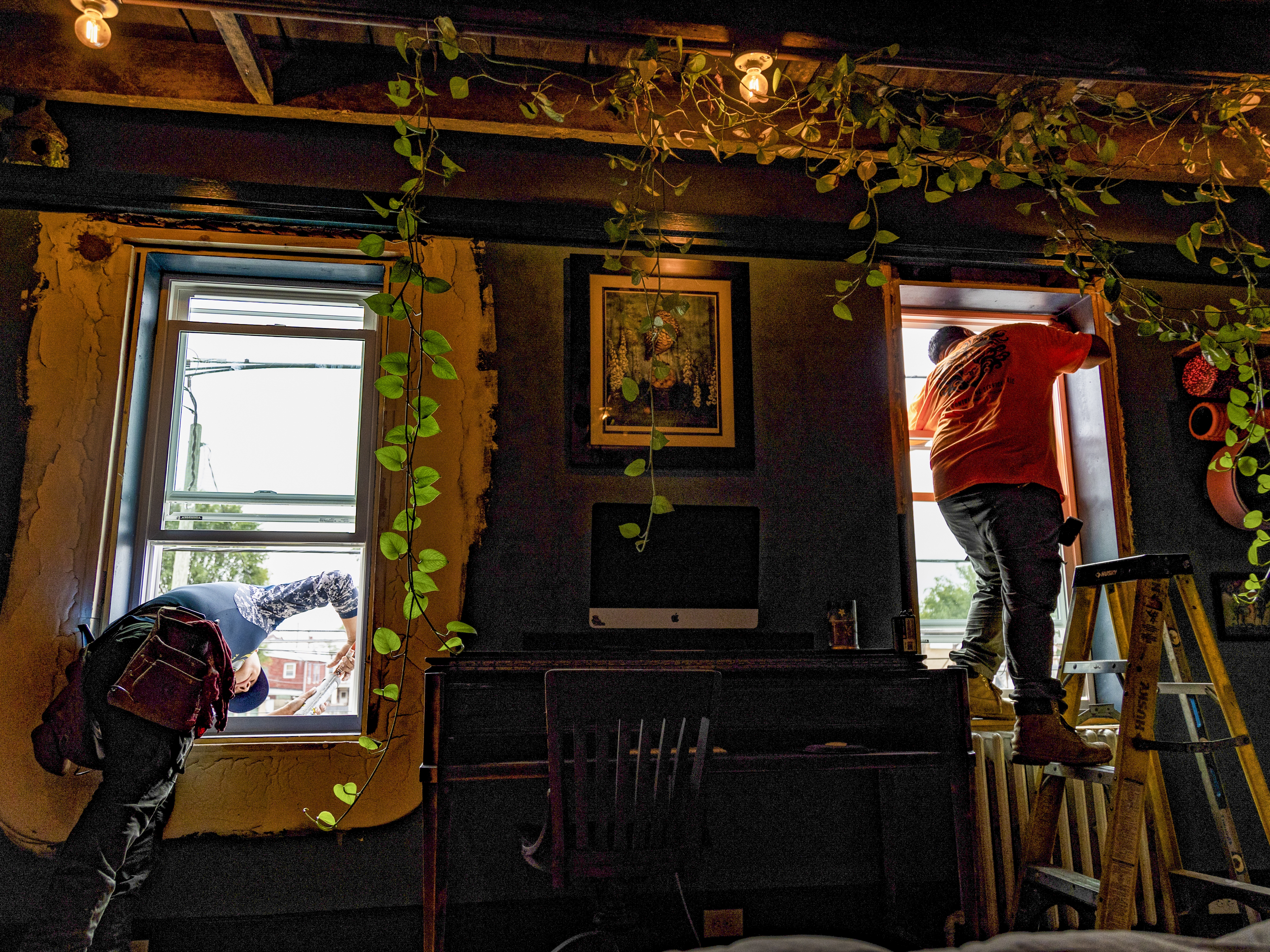 caption: Workers with Lyon Contracting Services install new windows in Tiffany's home in Kensington, a Philadelphia neighborhood that has been heavily impacted by the drug overdose epidemic. Free repairs at 400 homes in Kensington were paid for by settlement funds from opioid-related lawsuits. A Pennsylvania oversight board ruled that the repairs did not comply with guidelines on how the money should be spent.