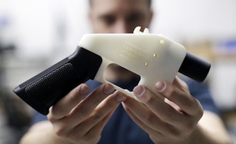 caption: FILE - In this Aug. 1, 2018, file photo, Cody Wilson, with Defense Distributed, holds a 3D-printed gun called the Liberator at his shop in Austin, Texas. 