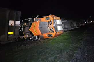 caption: A BNSF locomotive lies on its side after derailing on the Swinomish Reservation, in Anacortes, Washington, March 16, 2023. 
