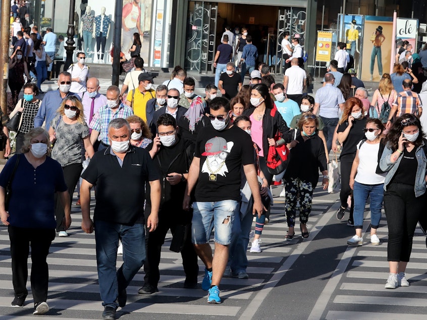 caption: People don face masks to help keep the coronavirus at bay in June in Ankara, Turkey. But what about earlier recommendations to stay 6 feet away from others and limit close contact to 15 minutes? Are these still effective against the contagious delta variant?