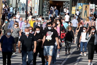 caption: People don face masks to help keep the coronavirus at bay in June in Ankara, Turkey. But what about earlier recommendations to stay 6 feet away from others and limit close contact to 15 minutes? Are these still effective against the contagious delta variant?