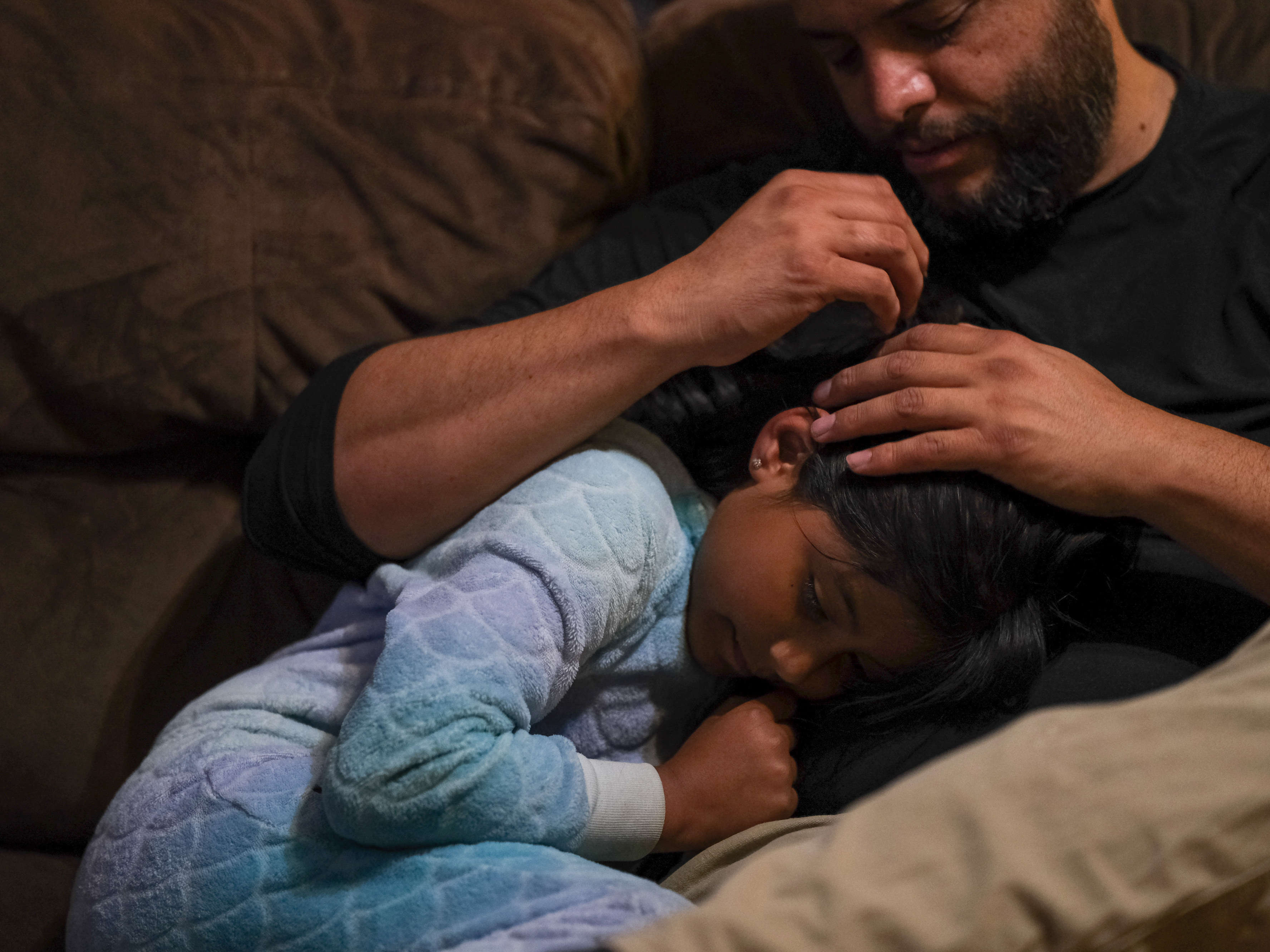 caption: Jose Grajeda and daughter, Victoria. <strong>"</strong>If I wanted to go to sleep as a child, I would go cuddle with my mom and she would give me <em>piojito</em>," he says — Spanish for "little lice." The late Peruvian linguist Martha Hidlebrandt described <em>piojito</em> as "gently scratching the scalp of a child as if he were being relieved of the itching of imaginary lice" — hence the name.