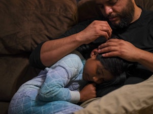 caption: Jose Grajeda and daughter, Victoria. <strong>"</strong>If I wanted to go to sleep as a child, I would go cuddle with my mom and she would give me <em>piojito</em>," he says — Spanish for "little lice." The late Peruvian linguist Martha Hidlebrandt described <em>piojito</em> as "gently scratching the scalp of a child as if he were being relieved of the itching of imaginary lice" — hence the name.