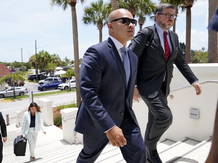 caption: Walt Nauta (left), an aide to former President Donald Trump, arrives with defense attorney Stanley Woodward for a July hearing in federal court in Fort Pierce, Fla.