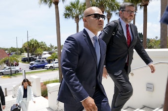 caption: Walt Nauta (left), an aide to former President Donald Trump, arrives with defense attorney Stanley Woodward for a July hearing in federal court in Fort Pierce, Fla.