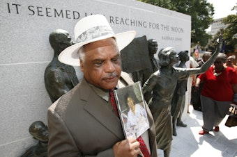 caption: A Maryland sculptor has been chosen to create a statute of civil rights activist Barbara Johns for the U.S. Capitol. In this photo from July 2008, Roderick Johns, brother of civil Barbara Johns, holds a photo of his sister at the newly dedicated Virginia Civil Rights Memorial on the grounds of the State Capitol in Richmond, Va.